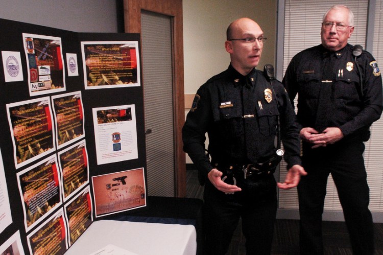 Waterville police Deputy Chief Bill Bonney, left, and Chief Joe Massey speak beside a display of opiate drugs and statistics on the increase of drug use after announcing a new program called Operation HOPE, or Heroin Opiate Prevention Effort, during a news conference Wednesday. The program combines enforcement, education and treatment for drug users.