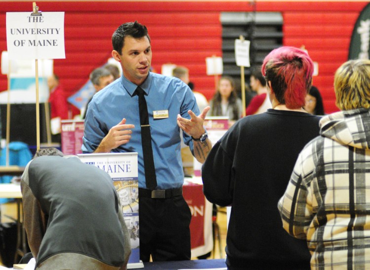 University of Maine representative John Tabor talks to students during a college and career fair Thursday in the Cony High School gymnasium. Representatives from postsecondary schools, business and the military were there to chat with students about opportunities after high school.