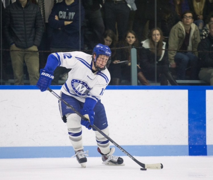 Colby College's Jack Burton looks to pass the puck in a game against Bowdoin College last season at Alfond Rink on the campus of Colby College in Waterville.