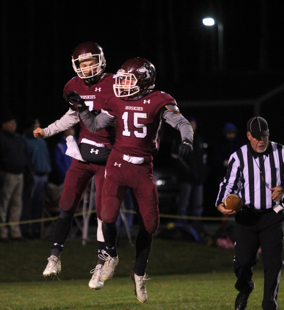 Maine Central Institute quarterback Josh Buker, upper left, celebrates a first-half touchdown run with Clark Morrison (15) during a Little Ten Conference semifinal game earlier this month in Pittsfield.
