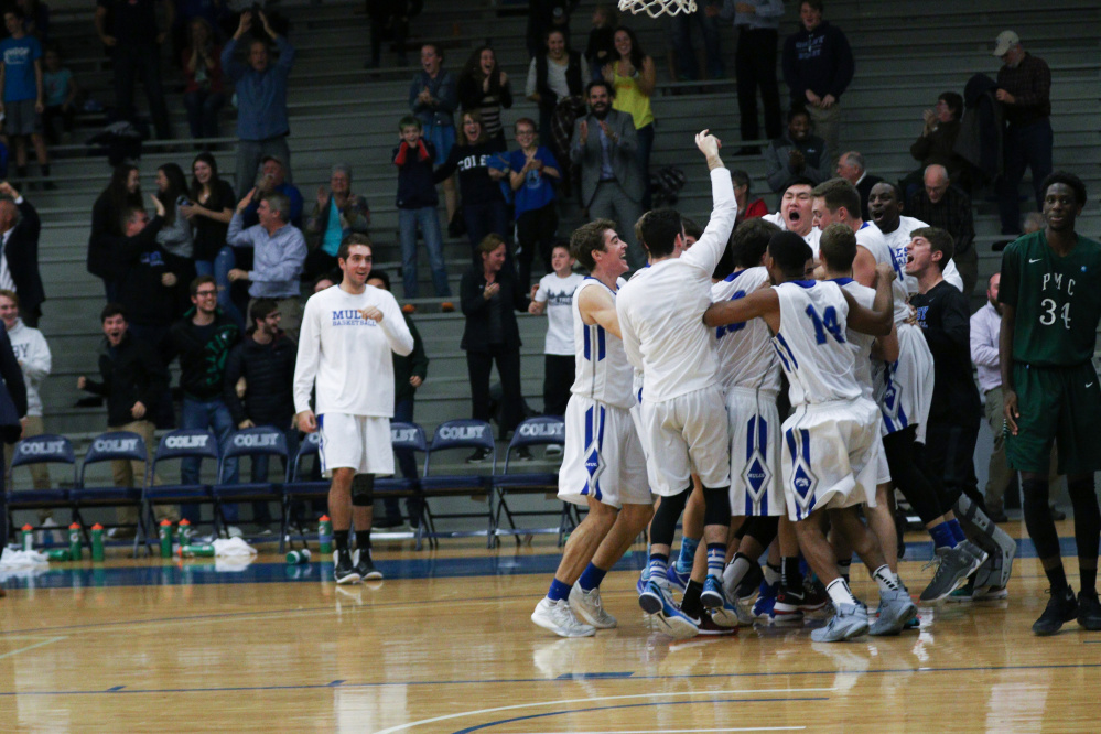 Members of the Colby basketball team celebrate after a 97-96 victory over Pine Manor on Friday in Waterville.