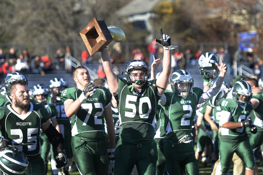Members of the Bonny Eagle football team — including Parker Gammon with Gold Ball in hand — walk off the Fitzpatrick Stadium field Saturday afternoon after winning the Class A state championship over Portland.