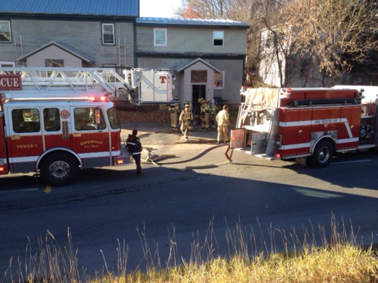 Firefighters work a fire at an apartment building on Front Street in Waterville Saturday.