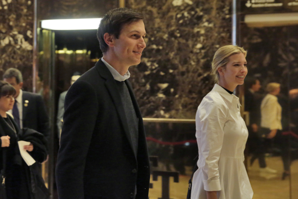Jared Kushner and his wife Ivanka Trump walk through the lobby of Trump Tower in New York on Friday.