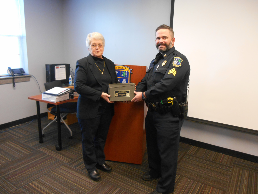 Jerry Shirley, Bill Shirley's wife, presents the Willard "Bill" Shirley Firearms Proficiency Award to this year's winner Sgt. Jason Longley of the Waterville Police Department.