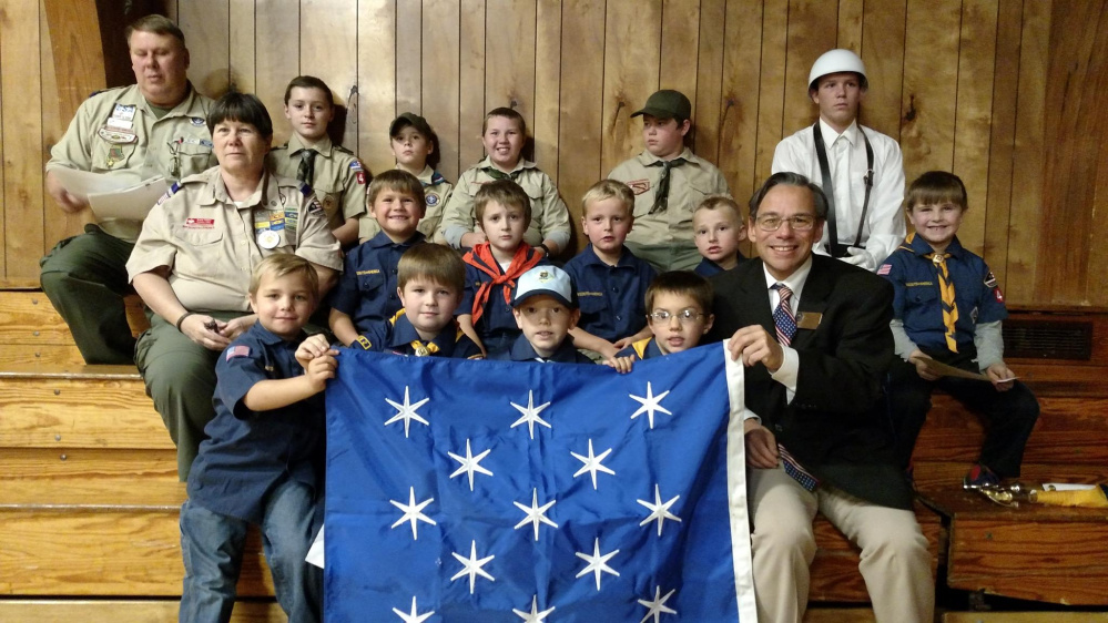 Jackman's Cub Scout Pack and Boy Scout Troop 497 gave a public presentation about Gen. George Washington during the Veterans Day ceremony on Nov. 10 at the Forest Hills School. It was the last requirement of the Scout Patriot Award. Scouts in the front, from left, are Remi Worster, Maddox Cuddy, Jacob Bennett, Xavior Ball and Chuck Mahaleris, Scouting Advancement chairman, of Augusta, displayed the Commander in Chief flag which was used whenever Gen. Washington was on the battlefield or at his headquarters such as Valley Forge. Middle row, from left, are Karla Talpey, Jaxon Desjardins, Matthew Hall, Brennan Begin, Rory Danforth and Vaughn Varney; and back, from left, are Alan Duplessis, Parker Desjardins, Tommy Sylvester, Robert Bouffard, Chris Someret and Hunter Cuddy.