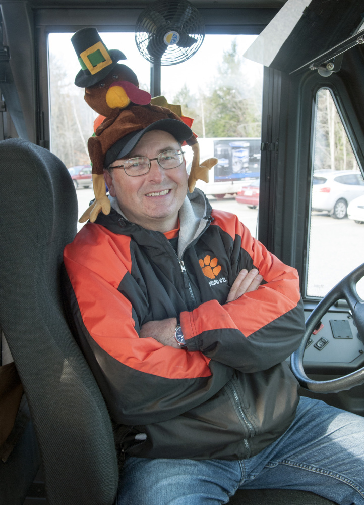 Bus driver Dean Maquette wears a turkey hat while sitting in lot before heading out on his route Tuesday at the school bus depot in Gardiner.