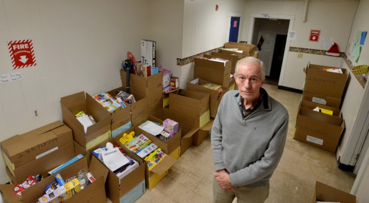 Steve Mayberry, development director at The Maine Children's Home for Little Wanderers, stands on Wednesday among boxes intended to be delivered to needy children for the Christmas season at the organization's home offices in Waterville. The nonprofit said Wednesday it still needs to fill about half of its boxes to meet its goal of serving more than 1,700 children this Christmas.
