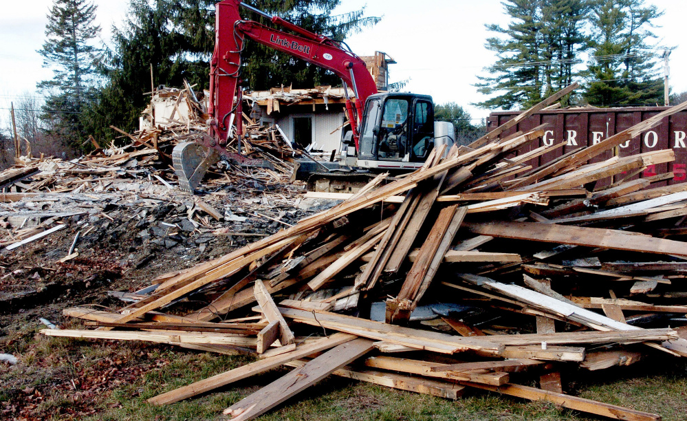 A farmhouse owned by the Trinity Evangelical Free Church in Skowhegan is torn down on Thursday. The two-story home at 84 Front St. in Skowhegan was demolished with plans to build a new 48-bed family shelter from the ground up.
