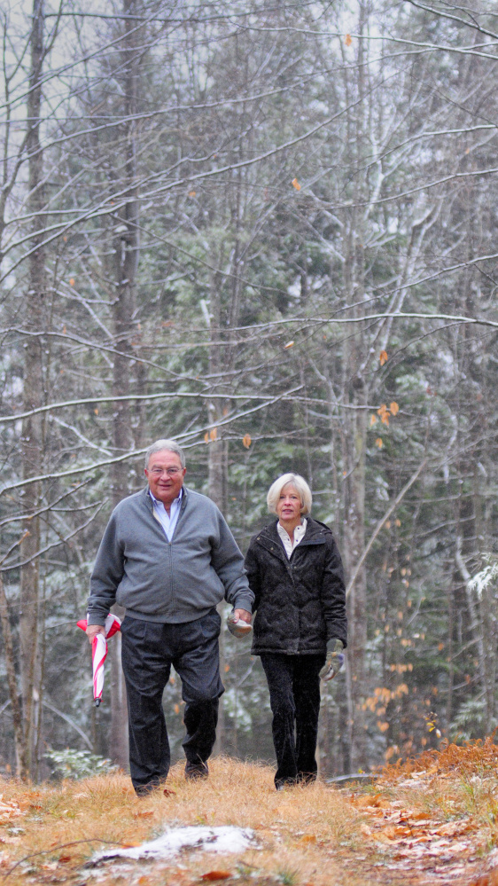 John and Lisa Rosmarin pose for a portrait on Friday in Readfield on land they donated to the Kennebec Land Trust.