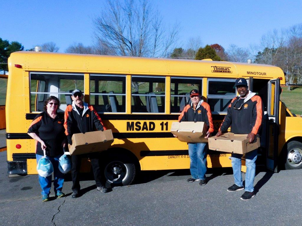 School Administrative District 11's two dozen bus drivers helped raise $250 toward buying turkeys for Gardiner Area High School students' annual Thanksgiving turkey drive. Because Cony Street Hannaford in Augusta donated 30 turkeys, the drivers will be able to dedicate the funds they raised for turkeys to buyping presents for Gardiner area children. From left are MSAD 11 bus drivers Dorothy Kirk, Richard Reutershan, Dean Paquette and Charles Wilson.