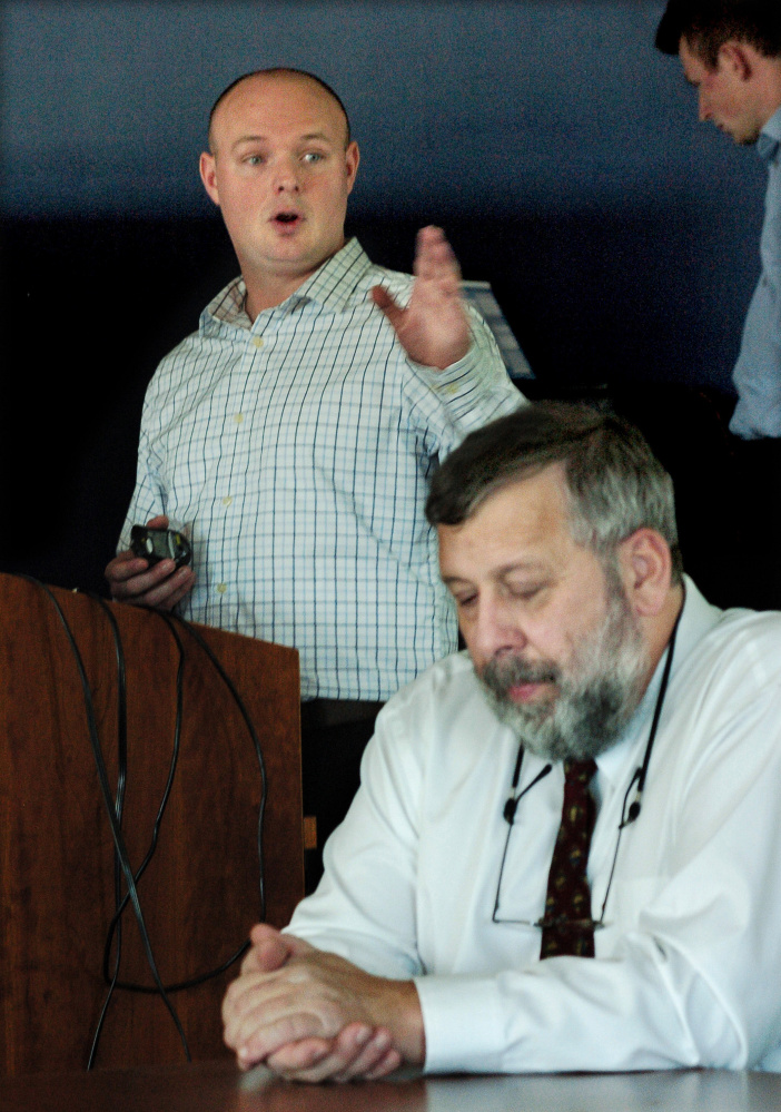Cameron Wellman of the Maine Emergency Management Association gestures as he addresses municipal, hospital and law enforcement officials during a cybersecurity talk at Thomas College on Monday. Thomas College professor Frank Appunn, in foreground, also spoke.