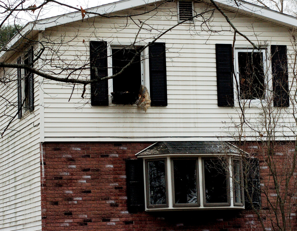 Blackened windows are left shattered and open Tuesday after fire the previous night damaged a home at 82 Mechanic St. in Norridgewock, displacing a family of five.