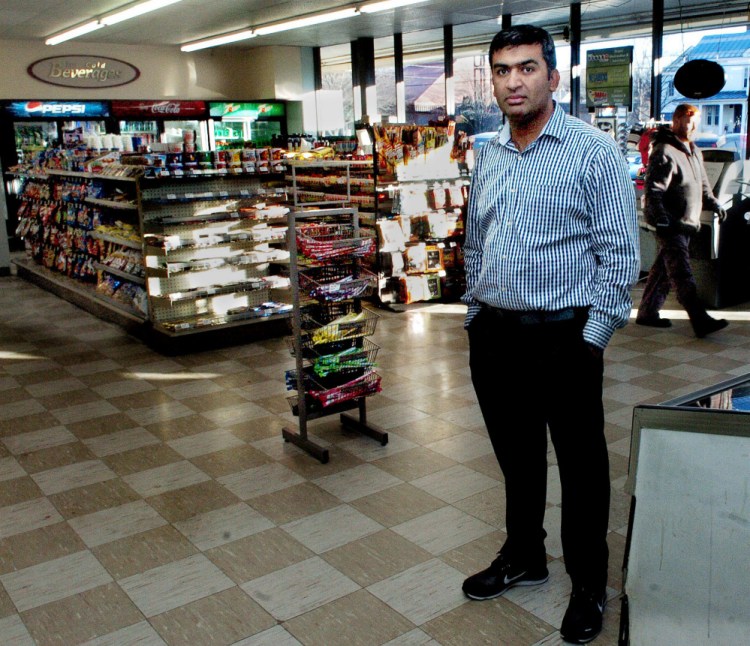 Ramesh Patel stands in the former Cumberland Farms store in Madison that he purchased as a delivery man brings in merchandise on Monday. The new store is called Country Farm 2.