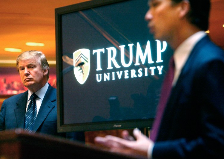 Real estate mogul and Reality TV star Donald Trump, left, listens as Michael Sexton introduces him at a 2005 news conference in New York where he announced the establishment of Trump University. A settlement was reached Friday in the civil fraud trial involving the now-defunct university. 