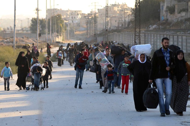 This Nov. 27 photo provided by the Rumaf, a Syrian Kurdish activist group, which has been authenticated based on its contents and other Associated Press reporting, shows people fleeing rebel-held eastern neighborhoods of Aleppo into the Sheikh Maqsoud area that is controlled by Kurdish fighters, in Syria. 
