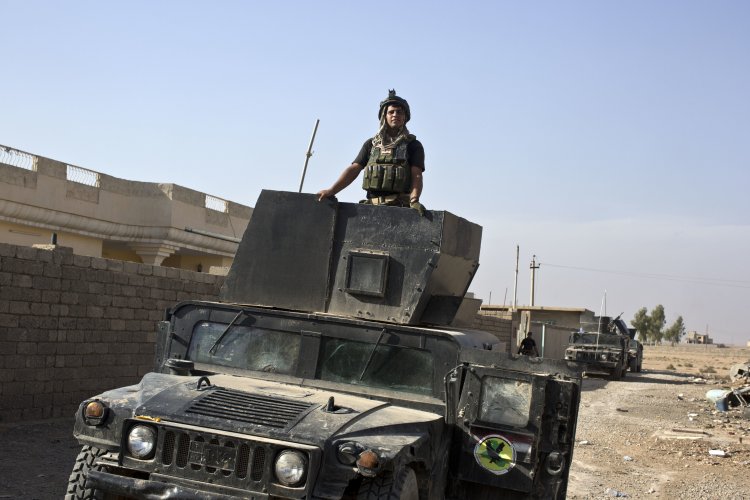 A member of the Iraqi special forces stands atop a Humvee in the village of Bazwaya, near the center of Mosul on Monday. Special forces entered Mosul on Tuesday in an offensive to drive out Islamic State militants. <em>Associated Press/Marko Drobnjakovic</em>