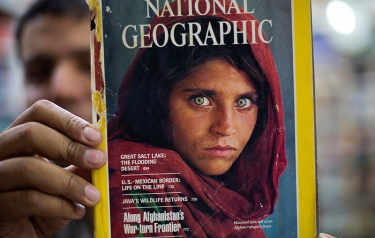 A copy of the 1984 National Geographic magazine with the photograph of Afghan refugee woman Sharbat Gulla.