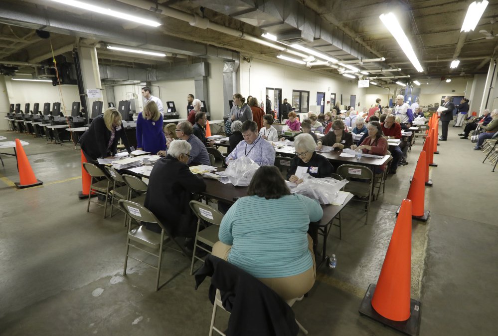 Workers begin a statewide presidential election recount Thursday in Milwaukee, Wisconsin.