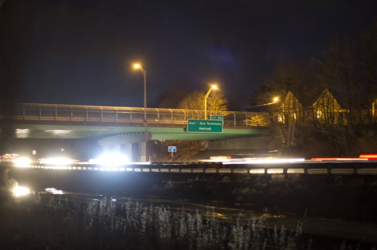Traffic passes under the Deering Avenue Bridge on Interstate 295 in Portland after nightfall Friday. Soil samples taken before and after four bridges were repainted showed elevated lead levels around the Deering Avenue Bridge.
