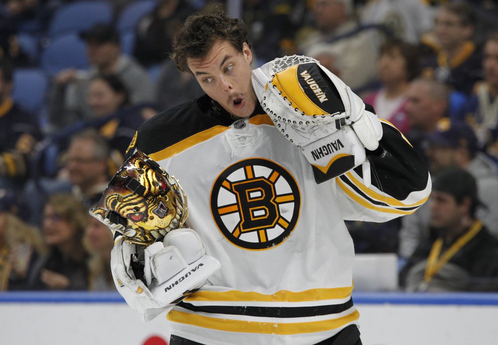Boston goalie Tuukka Rask reacts after being hit with a high stick during the first period against Buffalo. Rask made 35 saves and lead to Bruins to a 2-1 win. (Associated Press/Jeffrey T. Barnes)