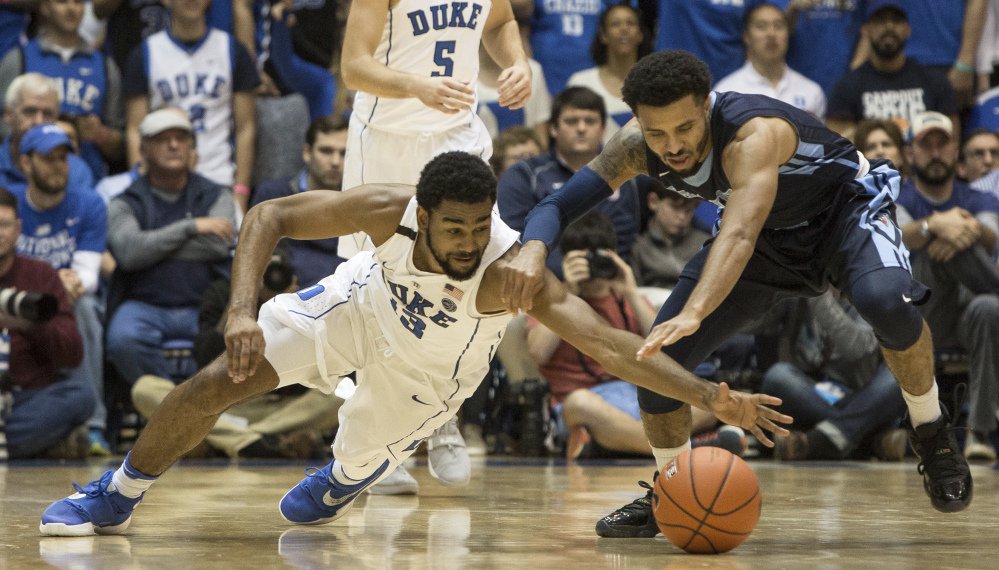 Duke's Matt Jones, left, and Maine's Austin Howard, right, fight for a loose ball during the first half of the Blue Devils' 94-55 victory Saturday in Durham, North Carolina.