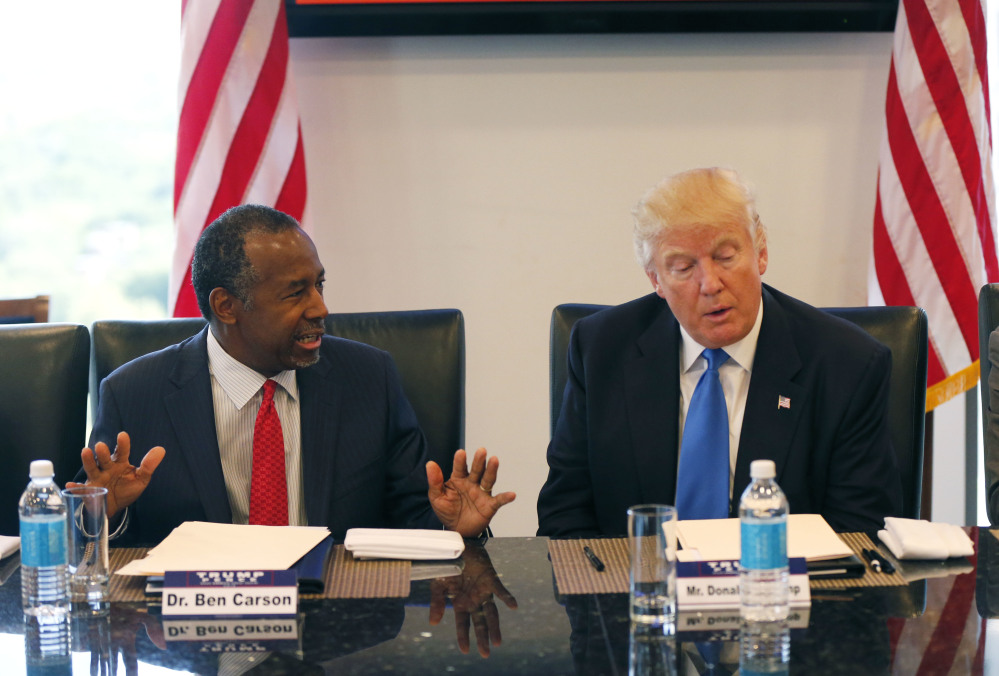 In this Aug. 25, 2016 photo, former Republican presidential candidate Dr. Ben Carson during Republican presidential candidate Donald Trump's roundtable meeting with the Republican Leadership Initiative in his offices at Trump Tower in New York. Trump has chosen former Campaign 2016 rival Ben Carson to become secretary of the Department of Housing and Urban Development.