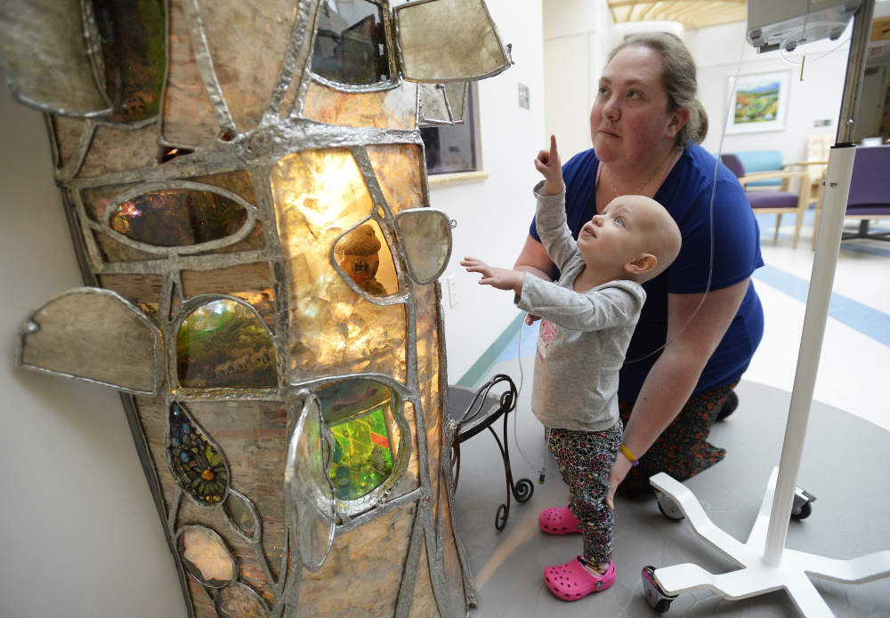 Patient Madison Arndt, 2, and her mother, Ashley, of Brunswick, explore the stained-glass tree dedicated Wednesday at the Barbara Bush Children's Hospital, part of Maine Medical Center in Portland.