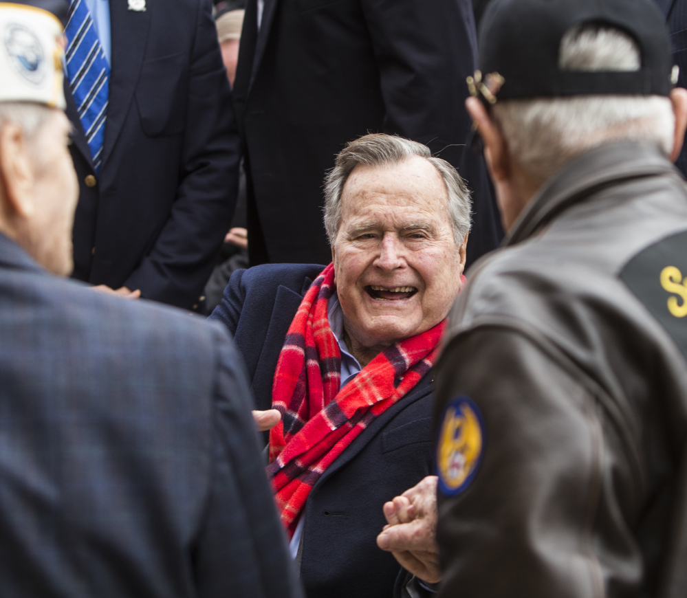 Former President George H.W. Bush greets World War II veterans at the conclusion of a Pearl Harbor remembrance ceremony at the George Bush Presidential Library on Wednesday in College Station, Texas.
