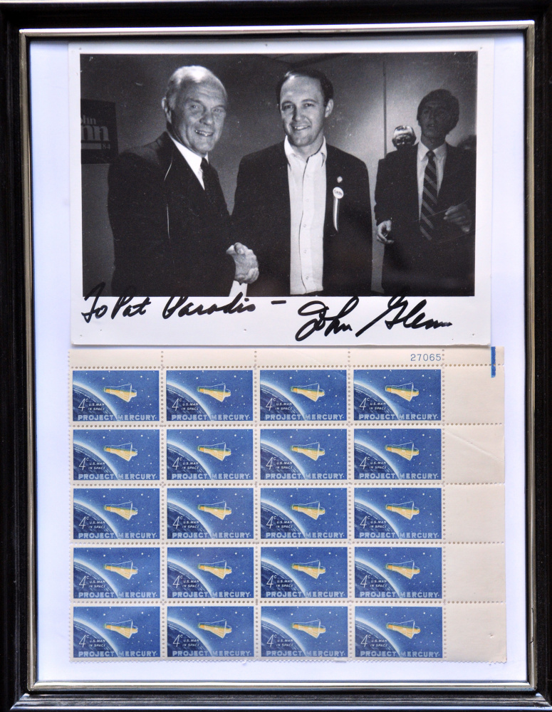 This autographed picture from 1983 shows the late Sen. John Glenn, left, and Patrick Paradis when the two met in Augusta while Glenn was campaigning for the 1984 Democratic presidential nomination. Framed with it is a sheet of stamps commemorating Glenn's 1962 space flight in the Mercury program.