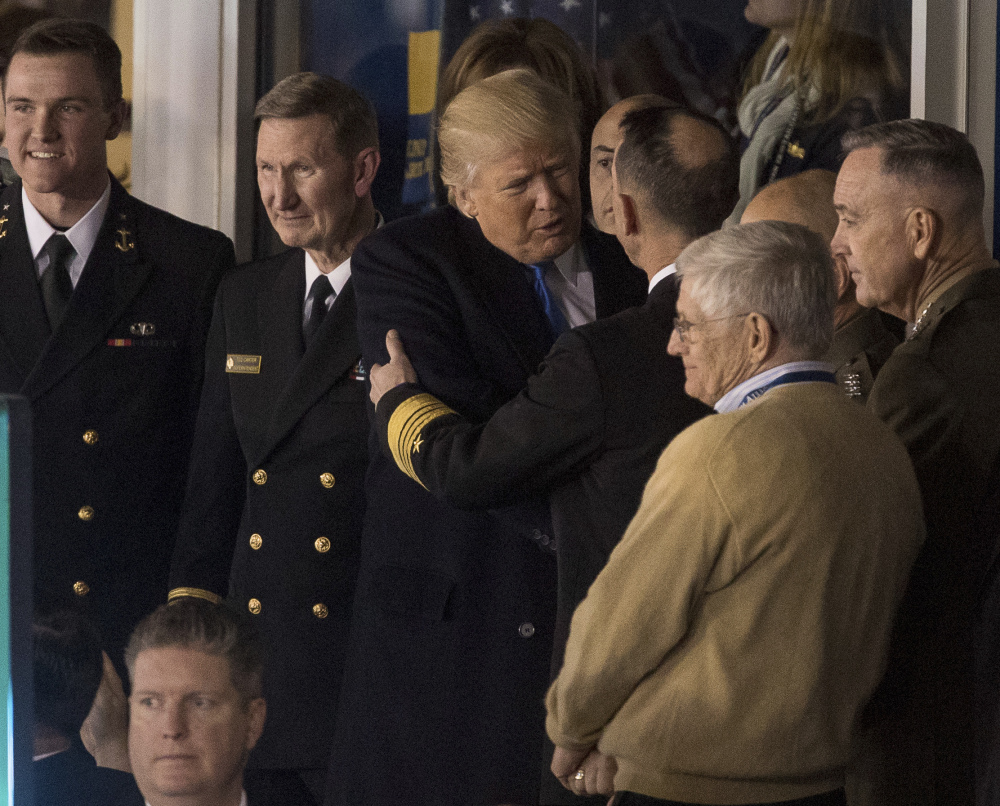 President-elect Donald Trump speaks with members of the military, during Saturday's Army-Navy college football game in Baltimore Saturday, won by Army.
