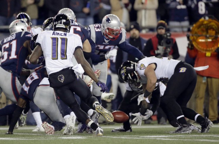 New England's Matthew Slater (18) loses the ball on a kickoff return in the second half, the second straight turnover that set up a touchdown for the Ravens.