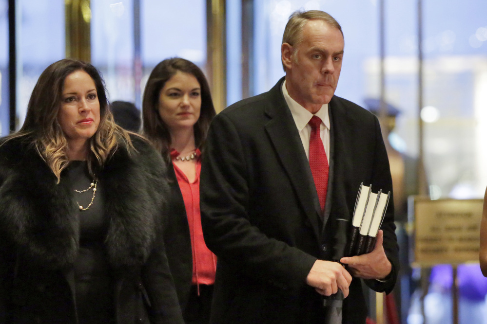 Rep. Ryan Zinke, right, R-Mont., shown arriving at Trump Tower in New York on Monday, is the president-elect's choice for secretary of the interior, according to a source with first-hand knowledge of the situation.