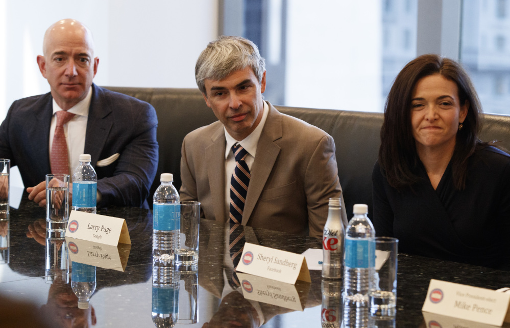 From left, Amazon founder Jeff Bezos, Alphabet CEO Larry Page and Facebook COO Sheryl Sandberg listen as President-elect Donald Trump speaks during a meeting.
