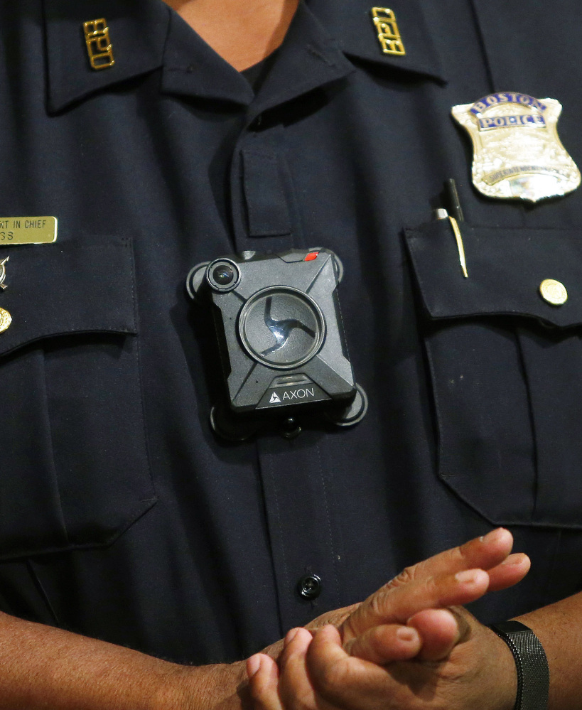 Boston Police Superintendent-in-Chief William Gross wears a body camera at a Sept. 12 news conference. Researchers said a study meant to assess the six-month pilot is not yet underway, and police haven't provided updates three months in, civil rights groups said.