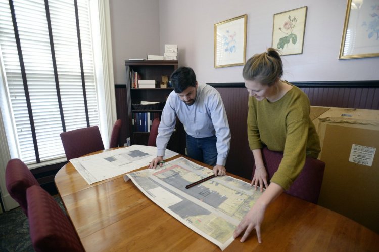 William Savage of Acorn Engineering in Portland looks over a site plan with design engineer Olivia Dawson on Thursday. <em>Shawn Patrick Ouellette/Staff Photographer</em>