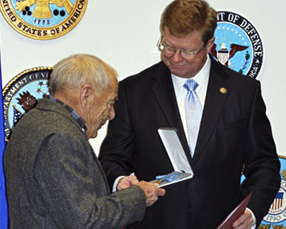 Nevada Rep. Mark Amodei, right, presents the Medal of Honor to Jerry Reynolds in Reno, Nev., on Monday.