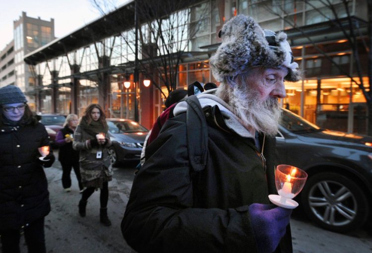 Alan Libby, who is homeless, marches up Preble Street during Wednesday's vigil in Portland. Libby, who will move to a home in Rumford in January, said he was participating in the event to remember his friend Randy, who died a week ago. During the annual vigil, held on the evening of the winter solstice, Portland mourns the loss of its most vulnerable; this year, 32 homeless people died in the city.