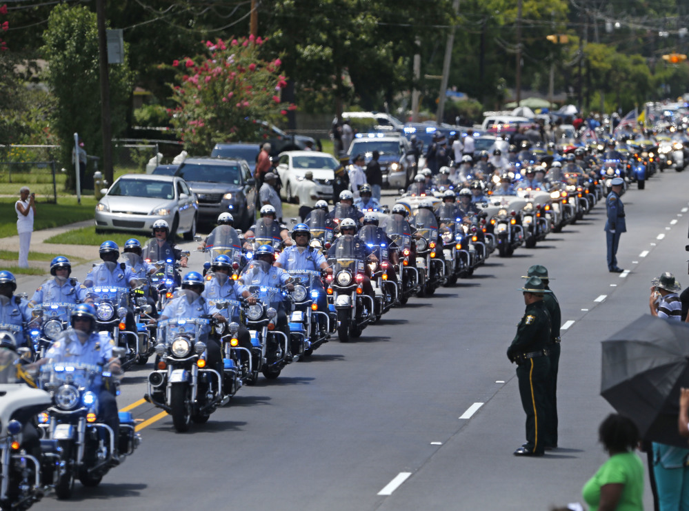 A funeral procession is held for Officer Montrell Jackson in Baton Rouge, La., on July 25.