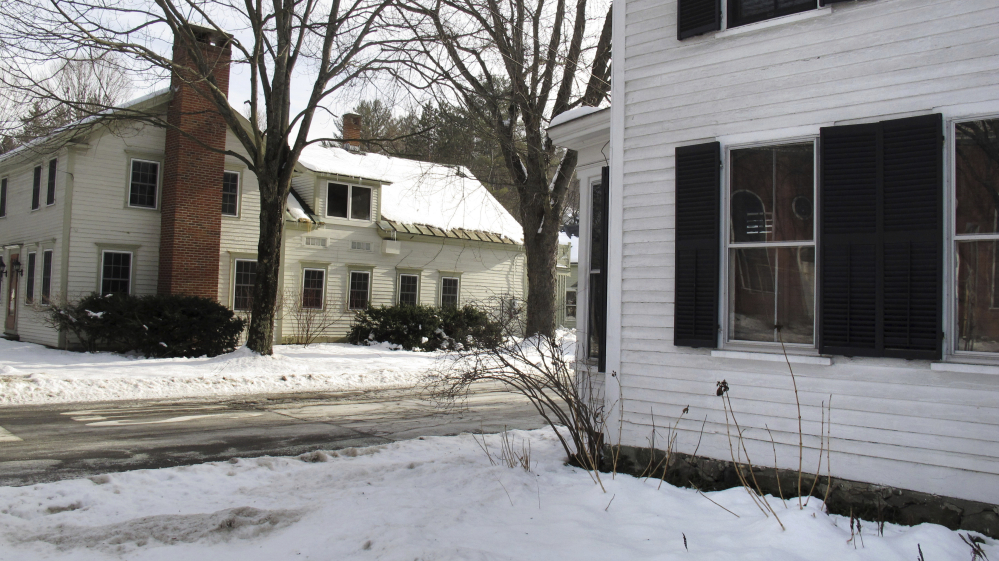 A home with shutters and another without are emblematic of the conflict in Woodstock, Vt., known for its historic New England charm. Some residents dispute a requirement that most buildings in the central distric have shutters.