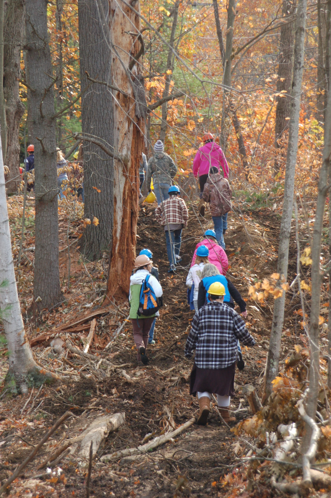 Buckfield students hike into the woods at the Kennebec Land Trust's 360-acre Curtis Homestead Conservation Area.