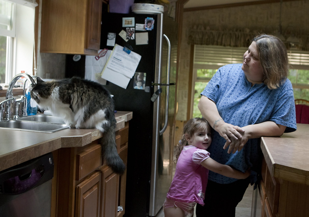 Wendy Brennan and her granddaughter, Madelyn Begin, stand in the kitchen of Brennan's home in 2014 in Mount Vernon. Brennan had a filter installed on her tap after she learned her drinking water contained arsenic.