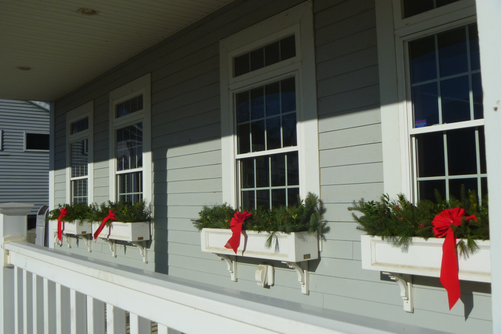 Evergreen boughs and red velvet ribbons adorn the flower boxes at the Newport Cultural Center, which houses the town's library.