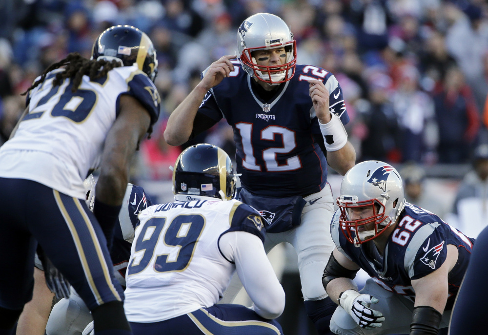 New England Patriots quarterback Tom Brady (12) calls signals at the line of scrimmage against the Los Angeles Rams on Sunday in Foxborough, Massachusetts.