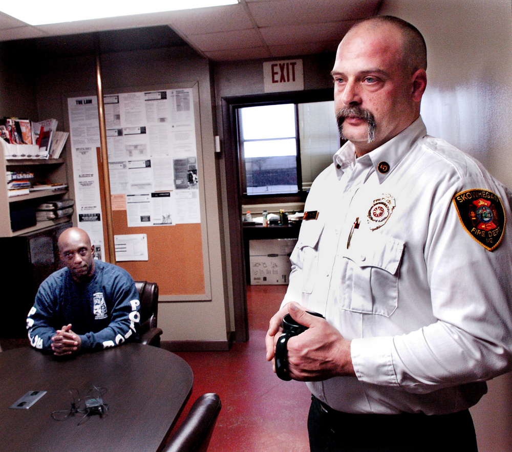 Skowhegan Fire Chief Shawn Howard, right, speaks about the recent fires in town on Monday. At left is Skowhegan police officer Tim Williams, who helped drag to safety a mother and son from their burning home on Friday.