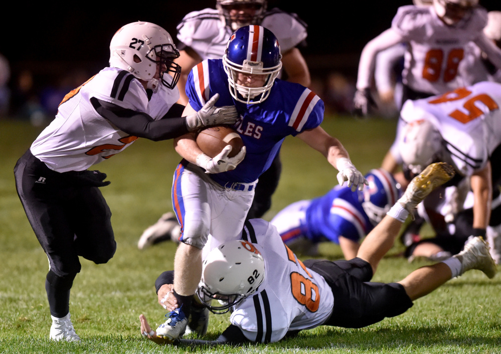 Messalonskee running back Austin Pelletier, center, breaks away from Skowhegan defenders during a game earlier this season. The MPA football comittee met for several hours Monday to discuss a number of ideas about high school football in the state.