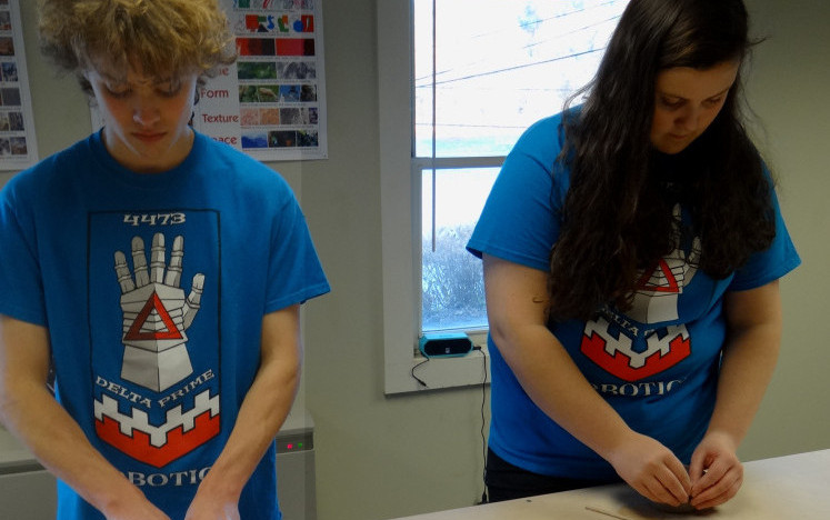 Team members William Fahy, left, and Hazel Houghton of Hall-Dale High School's Delta Prime Robotics learn to craft pinch pots at Hallowell Clayworks in preparation for their Pots for Bots family fundraiser on Sunday.