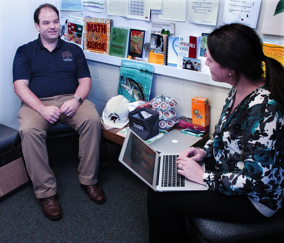 Cornville Regional Charter School Principal Travis Works and learning facilitator Susan Muzzy confer in an office Tuesday, the day when the school found out it has permission to expand from the existing kindergarten to eighth grade to pre-kindergarten to grade 12 next year.