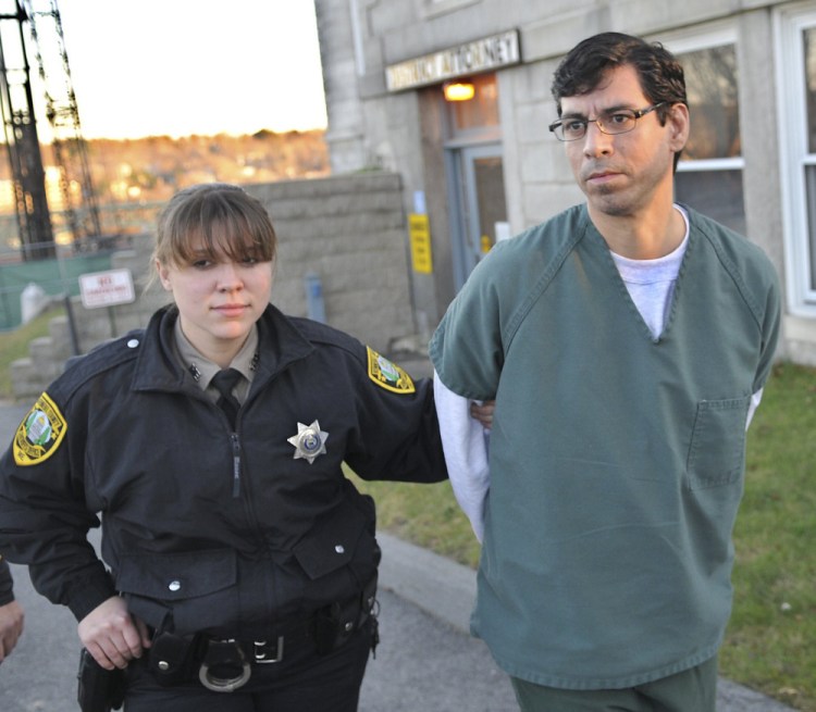 Michael T. Young is escorted to jail in this Dec. 6, 2012, file photo after pleading guilty to manslaughter at Kennebec County Superior Court for the June 2011 stabbing of his domestic partner David Cox in Augusta. Justice Michaela Murphy imposed the sentence of 12 years in prison, with all but six years suspended, and four years of probation.