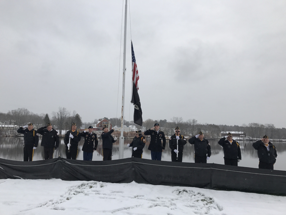 The Kennebec County Veterans Honor Guard raises the flag Wednesday during a ceremony in Gardiner to mark the 75th anniversary of the Japanese attack on Pearl Harbor.